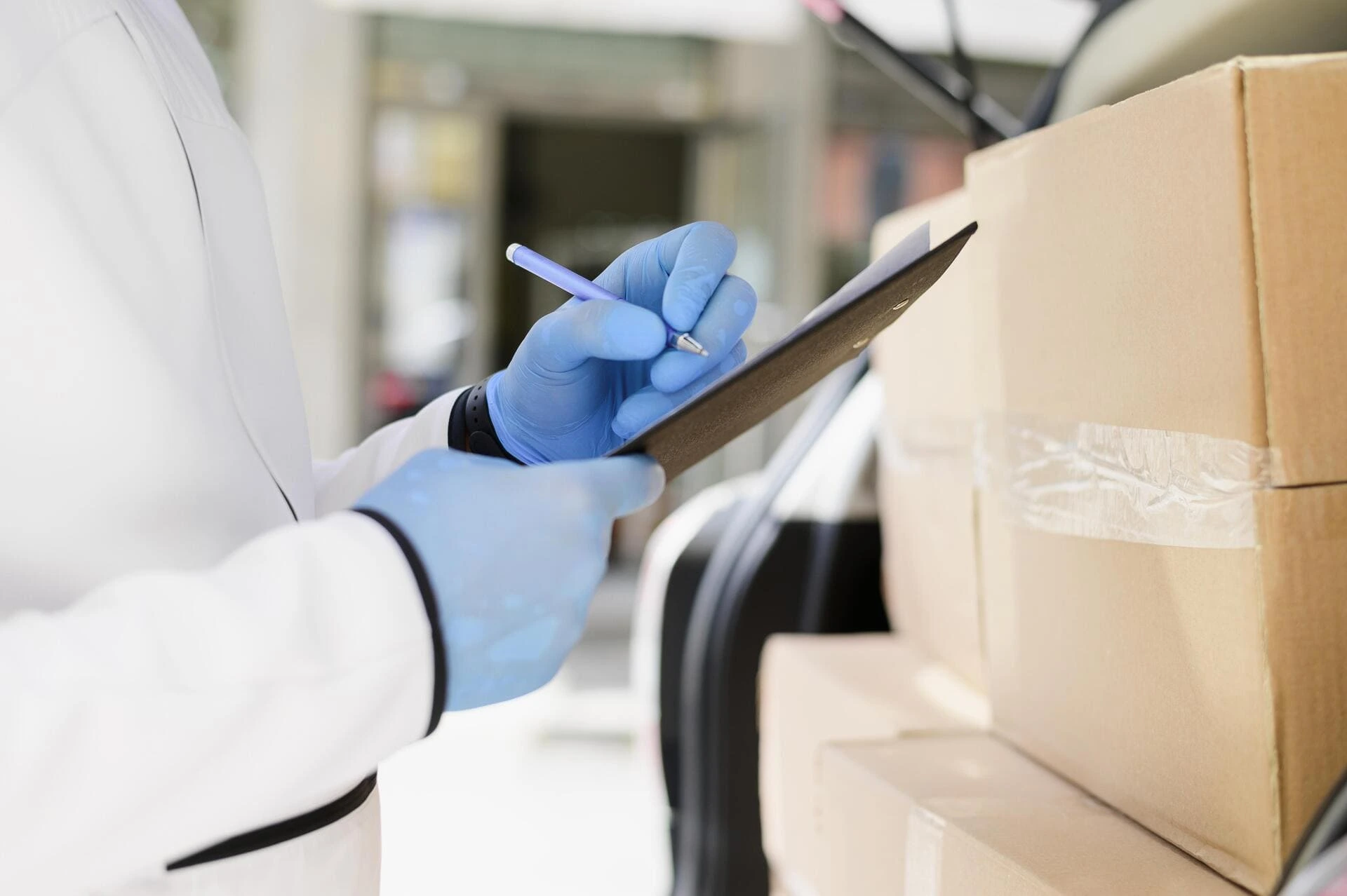 Person wearing gloves checking packages