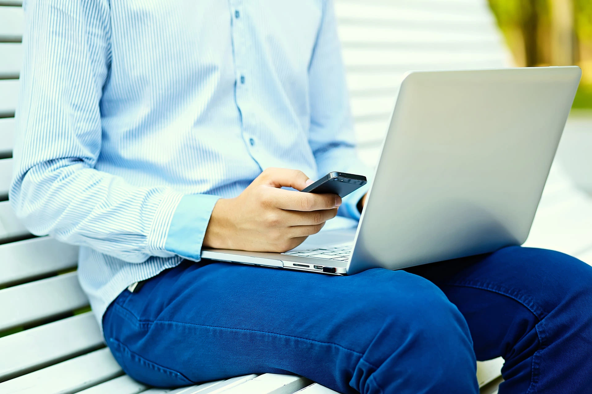 Man in shirt in front of computer and cell phone